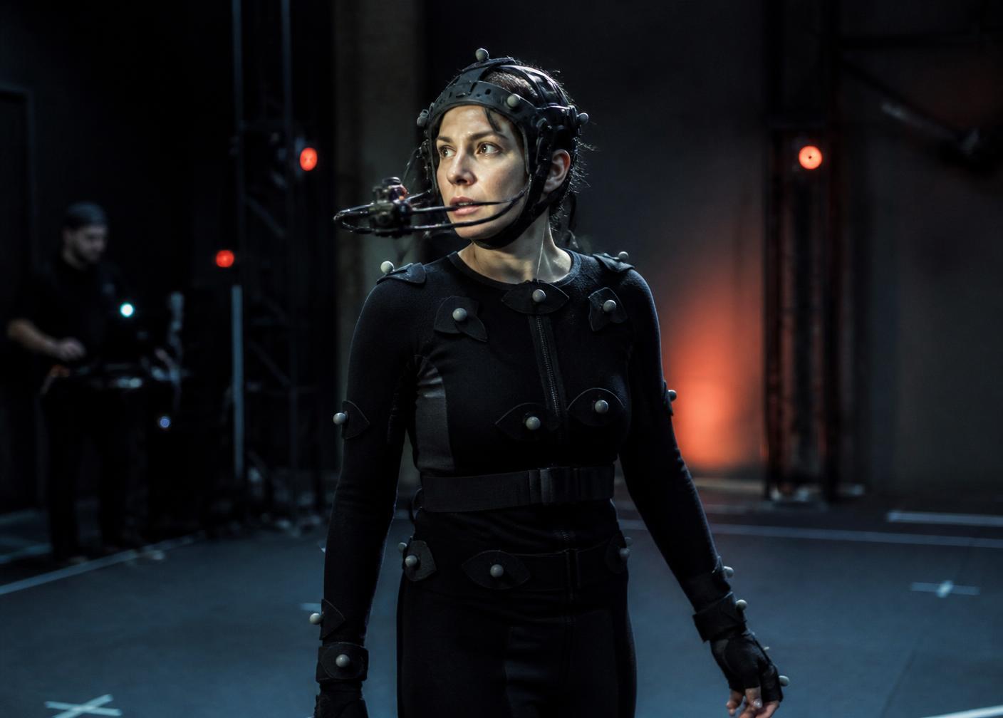 Performer in a marker suit and head-mounted camera rig inside a capture volume